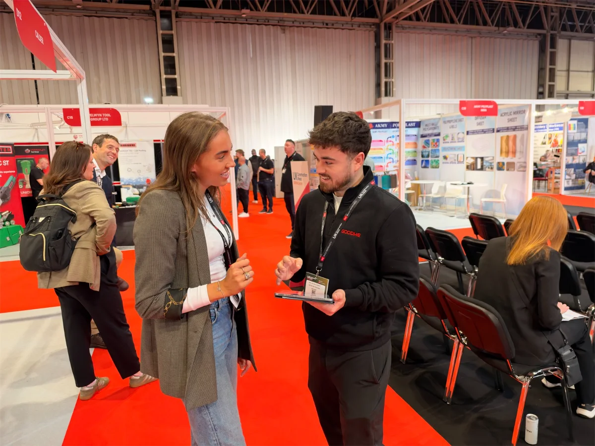 Two people talking on an exhibition stand at the NEC
