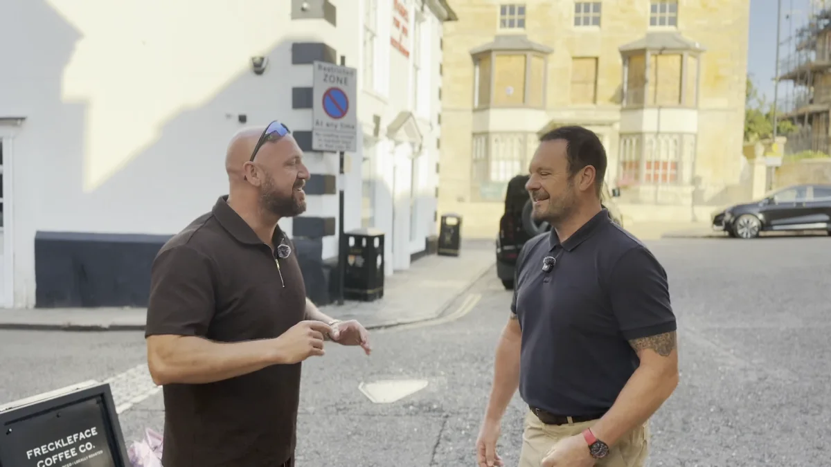 Two men talking in the street, from the APEX interview film
